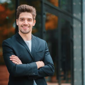 portrait-of-young-successful-confident-businessman-in-the-city-on-office-building-background-man-in_t20_AlnLA0